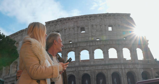 istock Mature tourist couple use mobile phone at viewpoint 2190861536