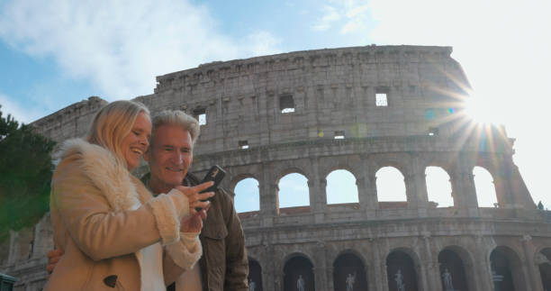 istock Mature tourist couple use mobile phone at viewpoint 2190861544