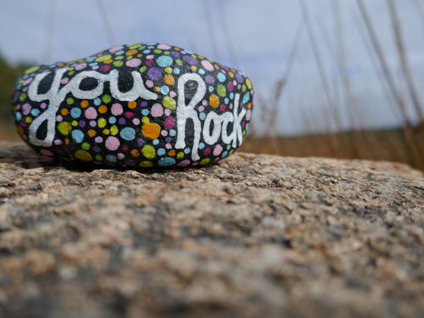 istock You rock kindness rock close-up with defocused grass in background 2190861662