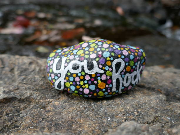 istock You rock kindness rock with defocused stream in background 2190862034