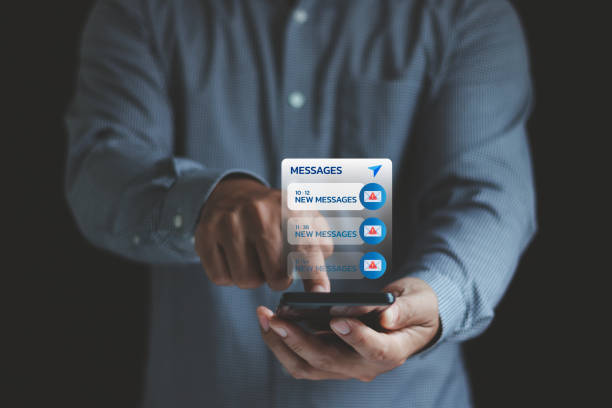 istock Email hack, System hacked warning alert, SMS spam, and fake text message phishing concept. scam malware spreading virus on messages alert virtual on mobile smart phone screen in businessman's hand. 2190864677