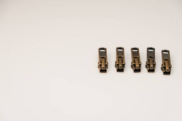 Some brown color zipper heads (slider) isolated on white background. It can use with zipper for making cloth, bag, skirt, jacket and etc.