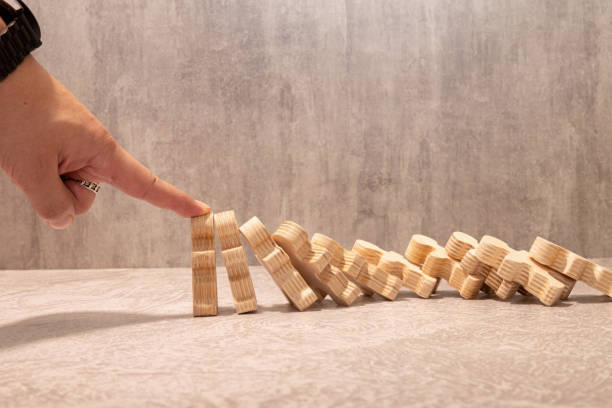 istock Domino effect in business. One businessman falls 2190866670