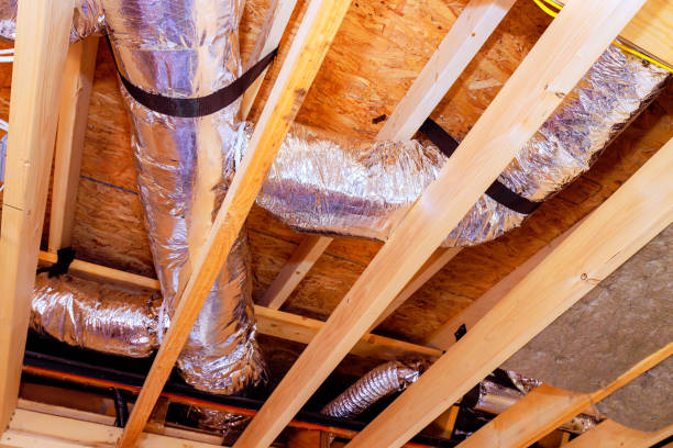 istock Ductwork installation visible in a residential ceiling with exposed beams during home renovation project 2190867981