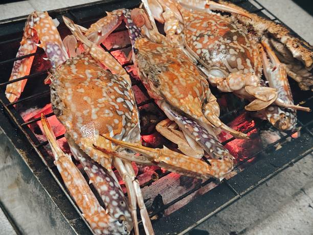 istock Grilled crabs on a barbecue grill over hot coals 2190869489