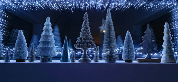 Window decorated with Christmas lights and Christmas trees.