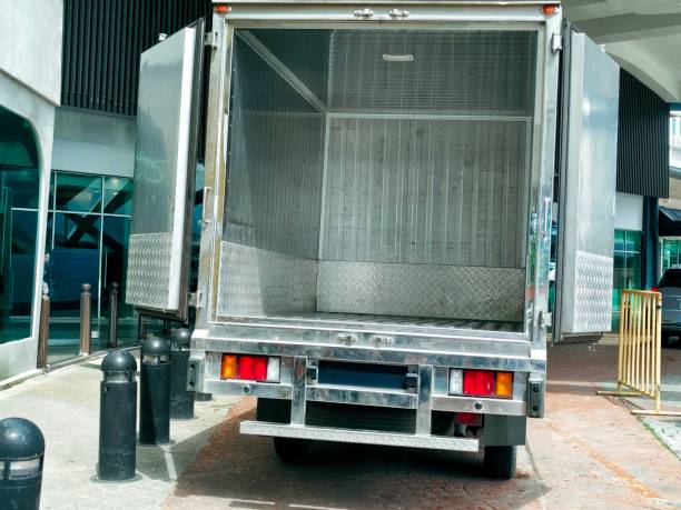 istock A cargo truck with its rear doors open, showcasing a clean metal interior 2190869797