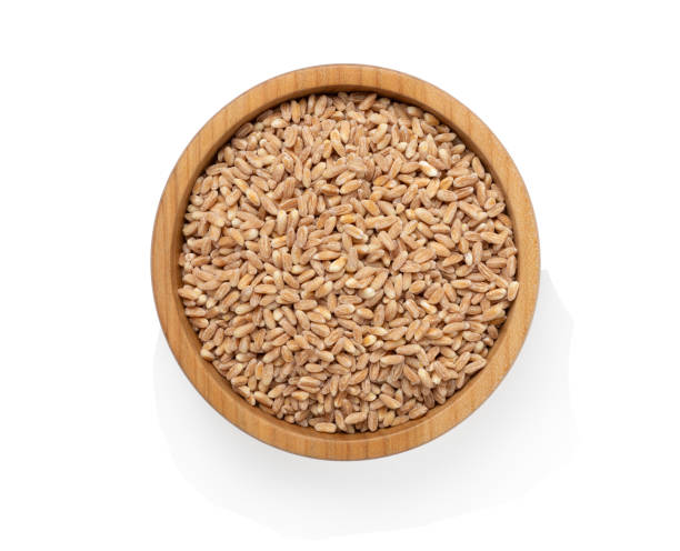 istock Wooden bowl with spelt grain isolated on white 2190870539