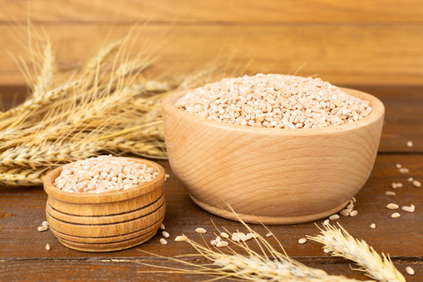 istock Bowl with spelt grain and ears on wooden table 2190870543