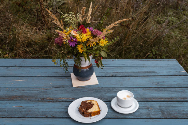 Wildflowers in a vase and cake and coffee on a picnic table, Friedrichswalde in autumn