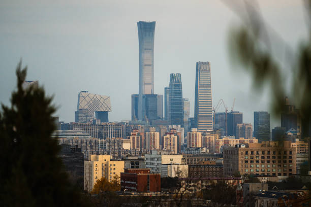 Clouds drifting across the blue sky over the iconic Canton Tower in Guangzhou, China. This landmark, located in the financial central business district (CBD), surrounded by office buildings, making it a renowned travel destination.