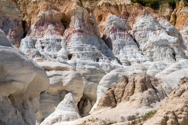 Paint Mines Park in Colorado. Colorful rock formations with layered textures resembling ancient cliffs at a remote location under bright daylight