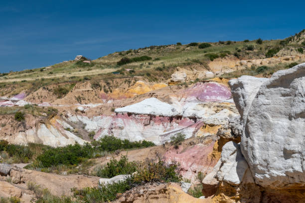 istock Vibrant hillside landscape showcasing colorful clay formations and lush greenery under a clear blue sky during midday, highlighting the natural beauty of the earth's palette in serene surroundings 2190876652