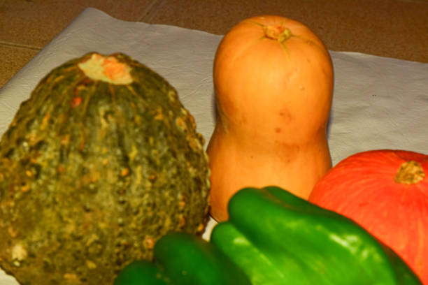 Pumpkins and green peppers on the table