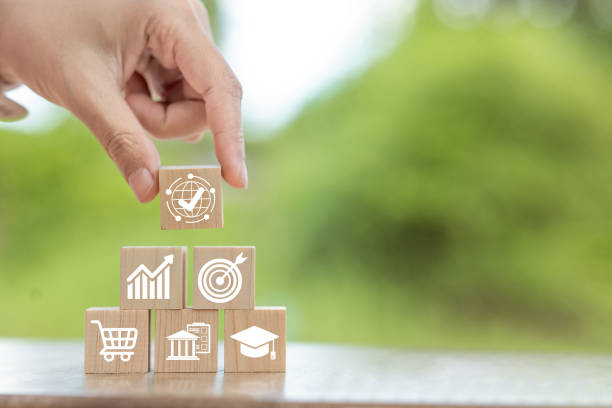istock A hand stacking wooden blocks with icons representing various sectors like global connections 2190882049