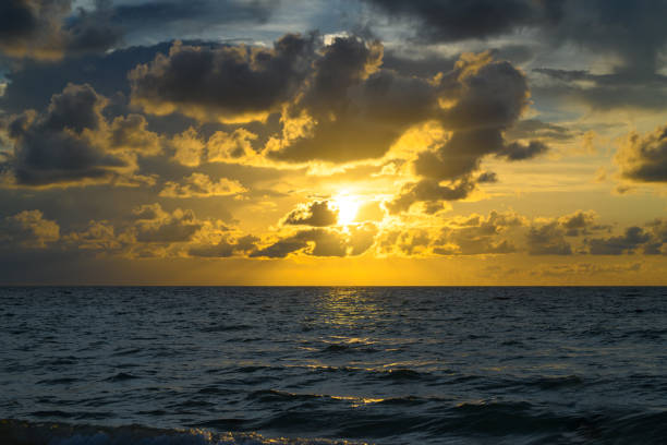 Colorful sky and sun rays. Stormy dramatic sky. Big cloud above ocean. Dark cloudy sky at sunset background. Cloud sky with sea background