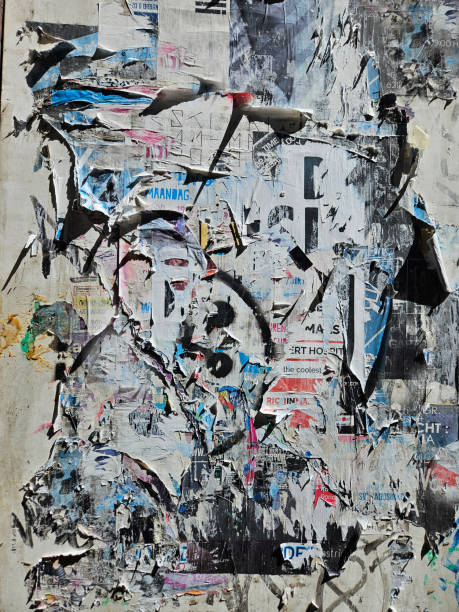 istock Abstract grunge background of torn, broken and smudged posters overlapping each other while hanging on a wall. 2190882922