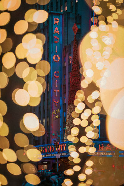 Radio City Music Hall marquee surrounded by bokeh Christmas lights. December 2024. New York City, NY. USA