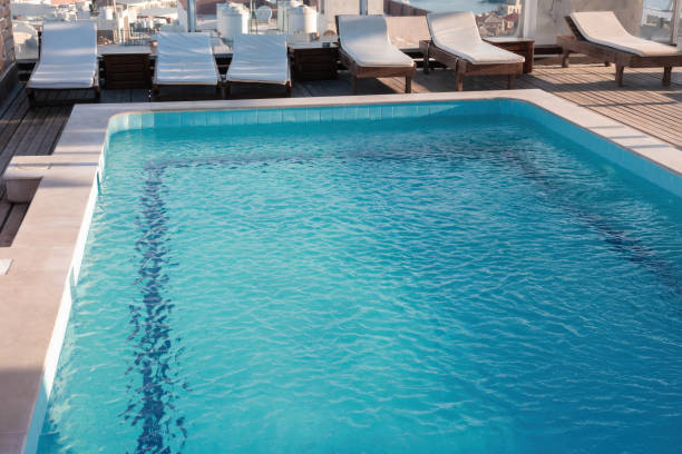 istock Rooftop pool with lounge chairs overlooking cityscape 2190886902