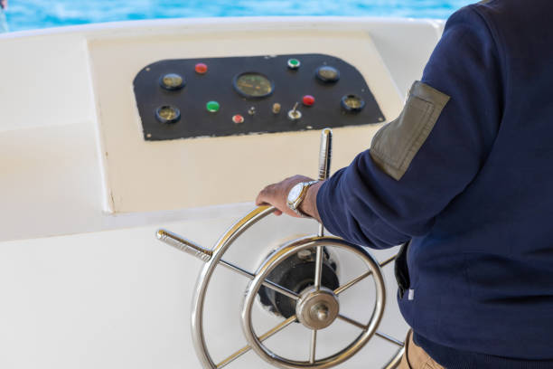 istock Boating adventure with steering wheel navigation on open waters 2190889017