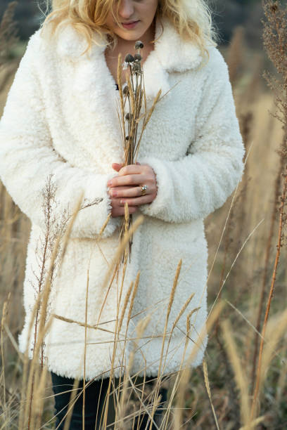 istock Femalel holding dried plants in a meadow 2190892420