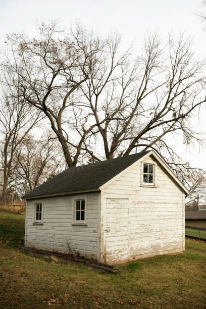 Old white barn in backyard of a modern neighborhood, Minnesota