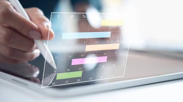 istock Business plan on calendar planner. Businessman manage business schedule for effective work. Calendar planner on virtual screen appointment reminders and meeting agenda, event planning. Time management concept 2190894400