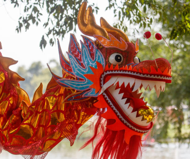 istock A dragon with a red mouth and orange tail is displayed in a tree 2190895639