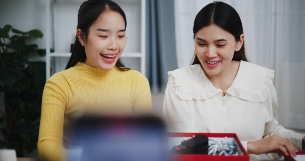 istock Two Asian influencers have a fun time unboxing and reviewing the camera, explaining the features and contents of the product. 2190897041
