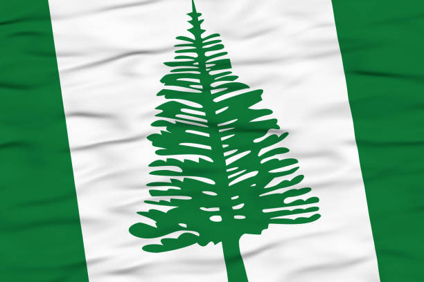 The flag of Norfolk Island is shown waving in the wind, featuring vertical green and white stripes with a Norfolk pine tree in the center. The design symbolizes the island's natural heritage and unique identity.