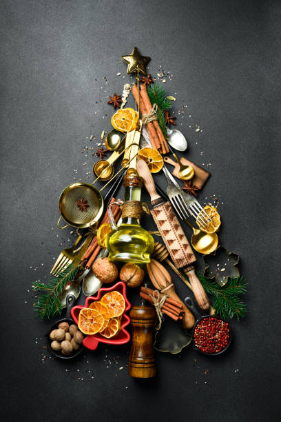 istock Christmas baking background with fir tree made from kitchen utensils, cookies, spices, cinnamon sticks, anise stars on rustic baking tray, top view 2190898190