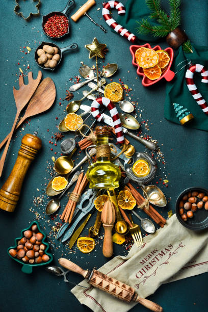 istock Christmas baking background with fir tree made from kitchen utensils, cookies, spices, cinnamon sticks, anise stars on rustic baking tray, top view 2190898194