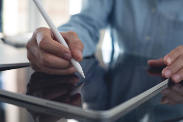 istock Business woman using stylus pen signing e-document on digital tablet via mobile app at office, proofing document, e-signing, electronic signature, business technology concept 2190899010