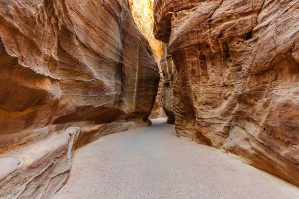 istock A scenic desert passage featuring towering rock formations with vibrant natural hues and textures. 2190899011