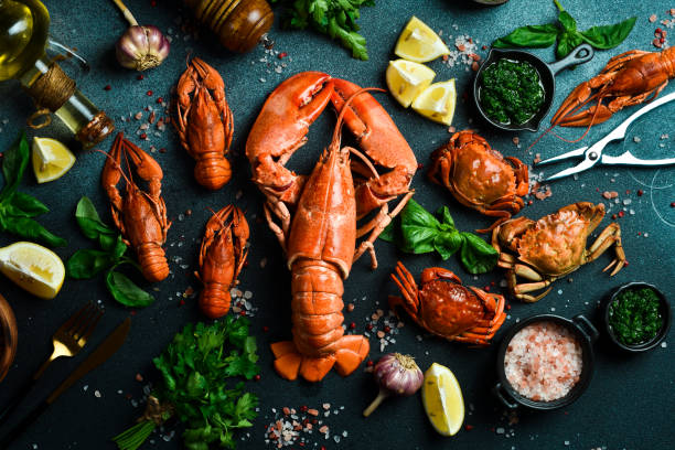 istock grilled lobster with lemon and basil on a black slate board. on a dark wooden table 2190899182