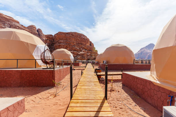 istock Luxury Desert Glamping Domes with Mountain Backdrop and Wooden Pathway 2190900615