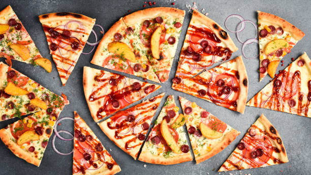 istock Pizza background. Set of pizza triangles with different flavors. On a gray stone background. 2190902502
