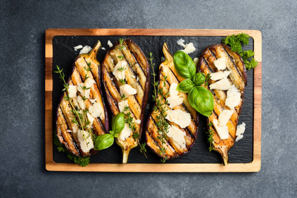 istock Baked eggplant with cheese and spices on a slate plate. Grilled vegetables. On a gray concrete background. 2190902607