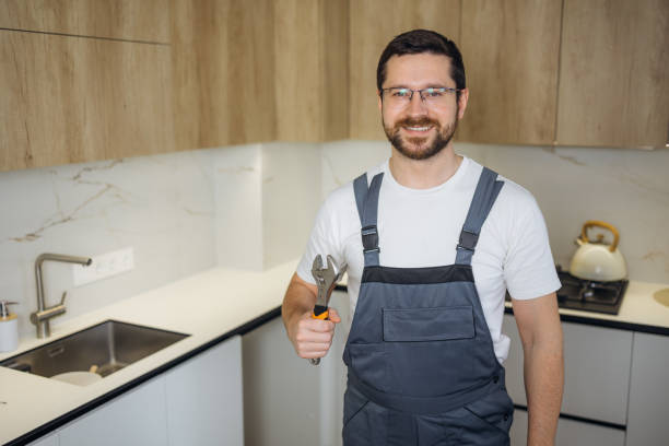 istock Young plumber holding pipe wrench in kitchen 2190903079