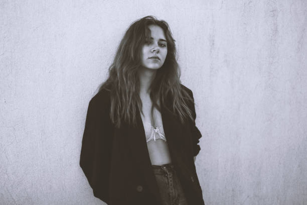 istock Beautiful Young Woman Leaning Against a Grey Wall 2190903293