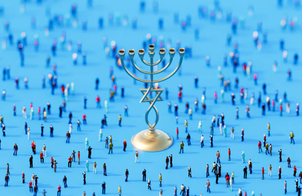 Gold colored Hanukkah menorah surrounded by people crowd on blue background. Horizontal composition. Hanukkah concept.