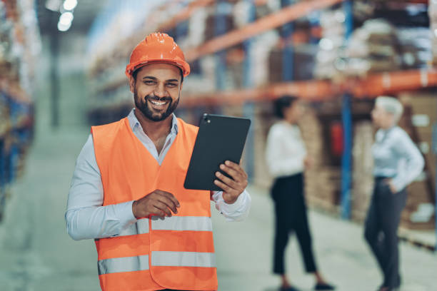 istock Portrait of a smiling young warehouse worker holding a digital tablet 2190907074