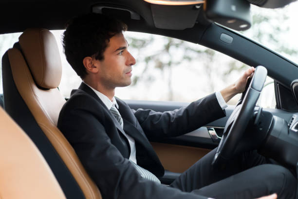 istock Businessman driving a luxury car on a sunny day 2190907638