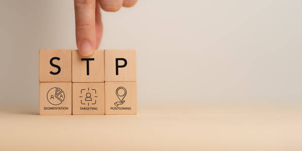 istock Segmentaion, targeting, positioning STP Marketing Model. Wooden blocks with STP icons.  Identify different customer groups, select groups to prioritize, and create brandâs unique value proposition. 2190908190