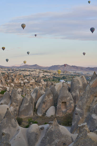 istock Hot air balloons flying over rock formations in Cappadocia, Turkey 2190909585