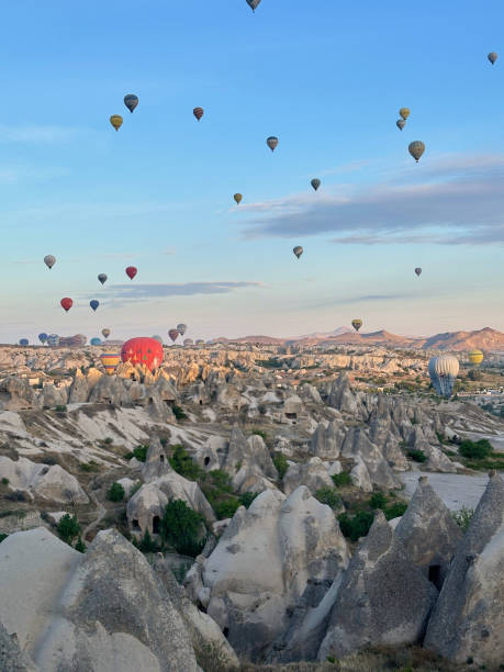 istock Hot air balloons flying over rock formations in Cappadocia, Turkey 2190909659
