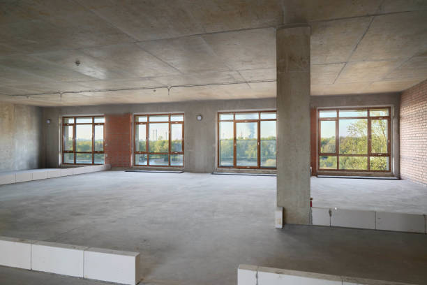 istock This spacious unfinished interior boasts large windows that allow for abundant natural light 2190910320