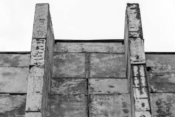 istock Rough weathered concrete wall is under bright sky. Abstract photo 2190910737