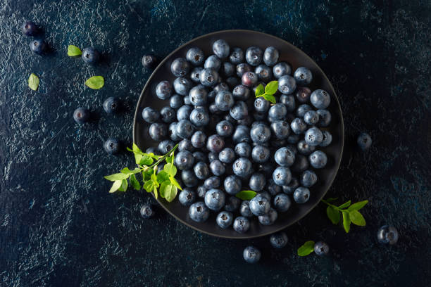 istock Blueberries in a black plate on a dark background. 2190910870