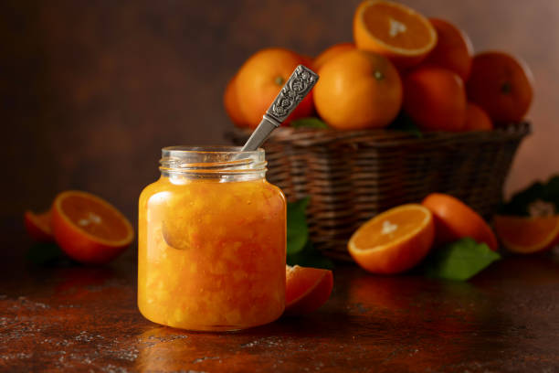 istock Orange jam and fresh fruits on a brown vintage table. 2190910874